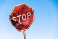 Damaged road sign stop covered with scratches Royalty Free Stock Photo