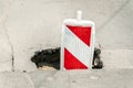 Street reconstruction or construction barricade traffic danger caution sign cover the open hole of damaged and cracked asphalt on