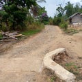 Damaged roads in villages are still rocky before being asphalted