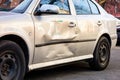 Damaged side door on a silver car after a small traffic accident Royalty Free Stock Photo