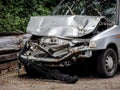 Damaged silver car with crashed frontal part