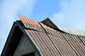 Damaged slate roof piece on a pitched roof