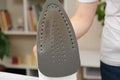 Damaged sole of the iron, brown stains and traces of burning with smoke and steam. Improper behavior during ironing