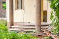 Damaged stairs and wall of domestic civilian villa house or building with hole without windows and doors destroyed by grenade in t Royalty Free Stock Photo