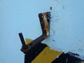 Damaged steel anchor hook on wall