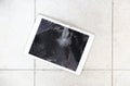 Damaged tablet computer lcd display on the floor Royalty Free Stock Photo