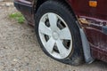 Damaged tire. The wheel of car tire leak. Flat tire on the off-road waiting for repair Royalty Free Stock Photo