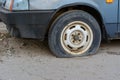 Damaged tire. The wheel of car tire leak. Flat tire waiting for repair. Abandoned car in the parking lot Royalty Free Stock Photo