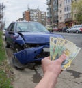 Damaged vehicle after car accident parked on the roadside. Car insurance concept with Romanian money lei Ã¢â¬â the cost of car Royalty Free Stock Photo