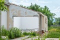 Damaged wall of domestic civilian house or building with hole and collapsed roof destroyed by grenade in the war zone after bombin Royalty Free Stock Photo