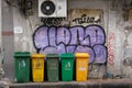 Damaged waste containers on narrow sidewalk