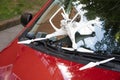 Damaged white drone on broken car windshield