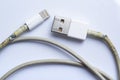 Damaged white usb cable plug and micro usb plug or Old Smart Phone Charger Cable broken on white acrylic background, Close up Royalty Free Stock Photo