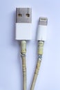 Damaged white usb cable plug and micro usb plug or Old Smart Phone Charger Cable broken on white acrylic background, Close up