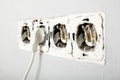 Damaged wires in electrical outlet in wall. Violation of electrical safety rules Royalty Free Stock Photo