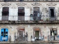 DAMAGED WOODEN DOORS AND WINDOWS ON OLD FACADE, HAVANA, CUBA Royalty Free Stock Photo