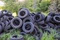 Damaged and worn old black tires on a stack. Damaged and worn old black tires on a stack. Tire tread problems. Solutions concept.