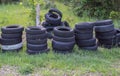 Damaged and worn old black tires on a stack. Damaged and worn old black tires on a stack. Tire tread problems. Solutions concept.