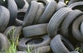 Damaged and worn old black tires on a stack. Damaged and worn old black tires on a stack. Tire tread problems. Solutions concept.