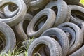Damaged and worn old black tires on a stack. Damaged and worn old black tires on a stack. Tire tread problems. Solutions concept.