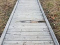 Damaged or worn wood boardwalk or trail with hole