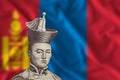 Damdin Sukhbaatar on the background of the Mongolian flag.