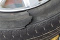Close-up of a damaged flat car tire Royalty Free Stock Photo