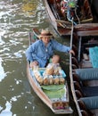 Dessert Seller sitting on her boat in the canal at Damnoen Saduak floating market. dessert: The taro slice into thin strips and