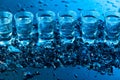 Damp glasses of vodka with ice on a black reflective background Royalty Free Stock Photo