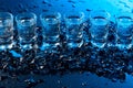 Damp glasses of vodka with ice on a black reflective background Royalty Free Stock Photo