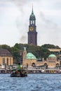 Panorama of the Port of Hamburg with an ancient steamboat at the foreground and the famous Michel Church in the background Royalty Free Stock Photo