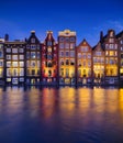 Damrak, Amsterdam, Netherlands. View of houses during sunset. The famous Dutch canals. A cityscape in the evening. Royalty Free Stock Photo