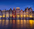 Damrak, Amsterdam, Netherlands. View of houses during sunset. The famous Dutch canals. A cityscape in the evening. Royalty Free Stock Photo