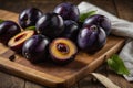 Damsons placed on a wooden chopping board Royalty Free Stock Photo
