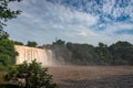 A yellow waterfall under a blue sky