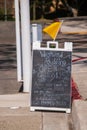 Sandwich board type street sign advertising a paddling and kayak rental business