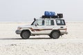 Danakil, Ethiopia, February 22 2015: an off-road vehicle with its driver waits for tourists in the salt desert of Danakil
