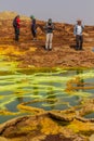 DANAKIL, ETHIOPIA - MARCH 24, 2019: Tourists observe colorful sulfuric lakes of Dallol volcanic area, Danakil depression