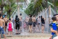 Vietnamese local people take a shower on the beach after swimming in the sea on the city Danang, Vietnam