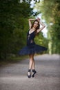 Dance and Ballet Ideas. Young Passionate Japanese Ballet Dancer in Black Tutu Demonstrating Ballet Pas in Summer Forest With