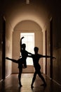 Elegant ballet dancers in dark corridor Royalty Free Stock Photo