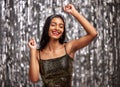 Dance, celebration and happy Indian woman in studio for party, birthday or disco against a silver background. Smile Royalty Free Stock Photo