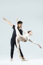 Dance Couple of Asian Young Man and Caucasian Woman Performing As Ballet Dancers Over Grey in Studio During Suppots As Classical Royalty Free Stock Photo