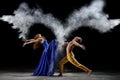 Dance duet with the powder mixtures in the dark. Royalty Free Stock Photo