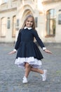 Dance etiquette. Happy child make curtsy outdoors. Small dancer wear school uniform. Back to school fashion. Dance