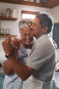 Dance the grey away. a happy mature couple dancing together while cooking in the kitchen at home. Royalty Free Stock Photo