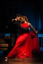Dance and love concept. Young couple in elegant evening dresses posing in the room filled with dramatic light. Two Royalty Free Stock Photo