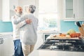 Dance, love and a senior couple in the kitchen of their home together during retirement for bonding. Happy, smile or Royalty Free Stock Photo