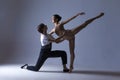 Dance Photography Ideas. Professional Ballet Dance Couple Performing Together in Studio While Girl Posing in Bodysuit Against