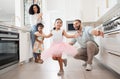 Dance, princess and family with children in home kitchen for love, care and fun bonding together, clapping or